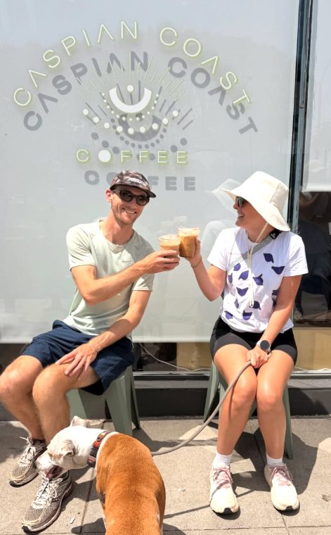 Cheers with iced coffee outside the café