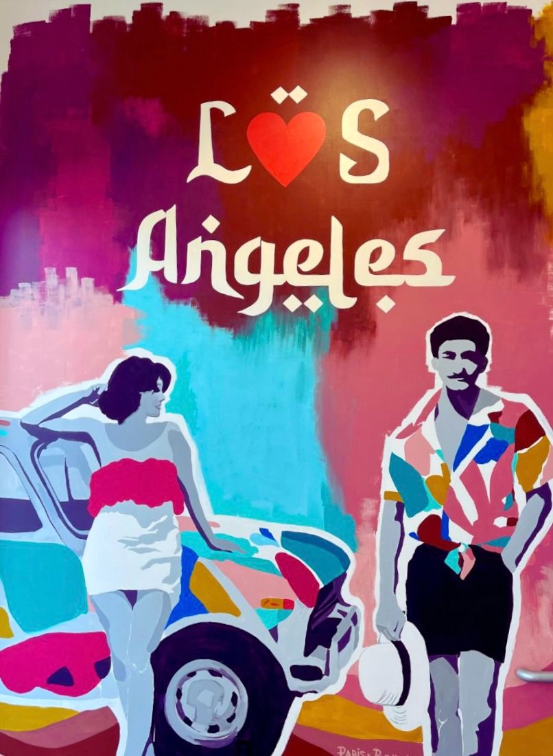 The LÖS Angeles mural by Parisa Parnian — a couple beside a vintage car beneath hand-painted lettering