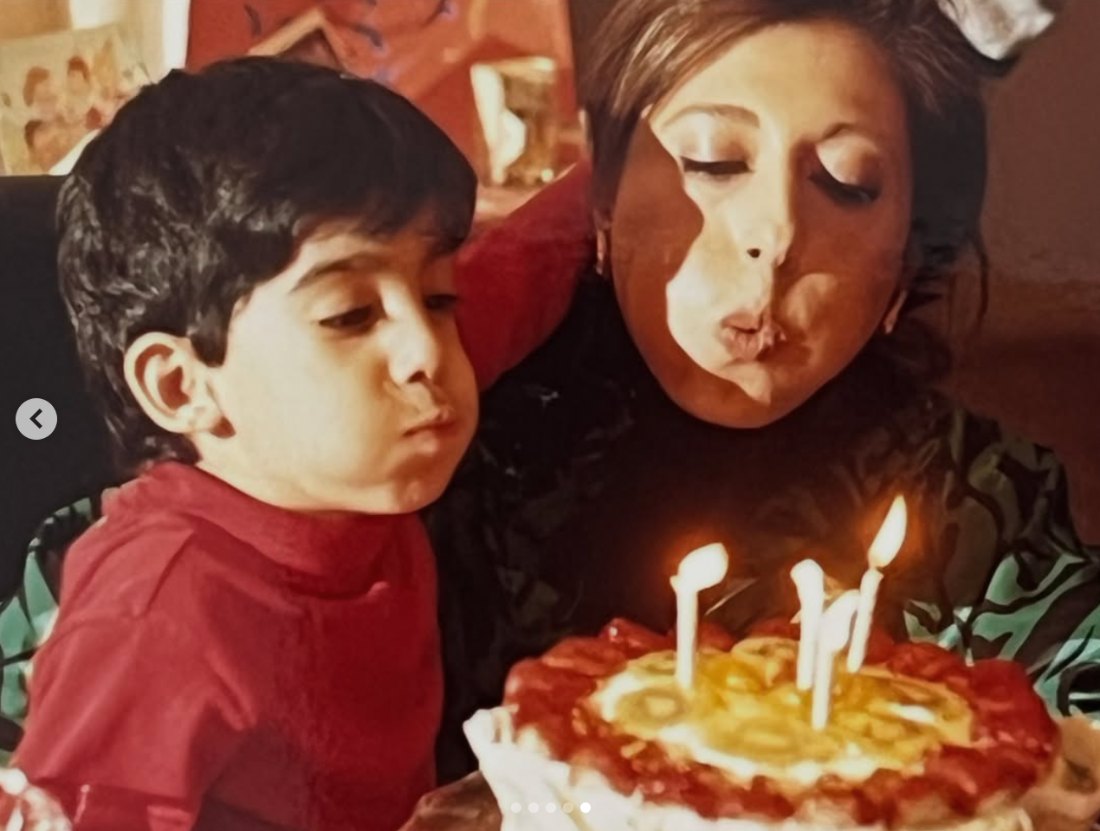 Rahi as a boy with his mother, blowing out birthday candles